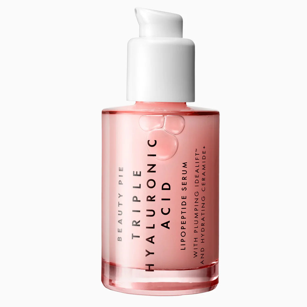 Beauty Pie Triple Hyaluronic Acid Lipopeptide Serum in a clear bottle showing pink liquid, with a white pump dispenser, on a clean white background.