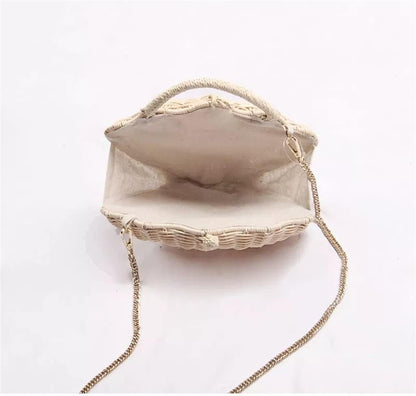 Grace Beauty shell-shaped raffia clutch handbag with woven design, crossbody strap, and pearl accents.