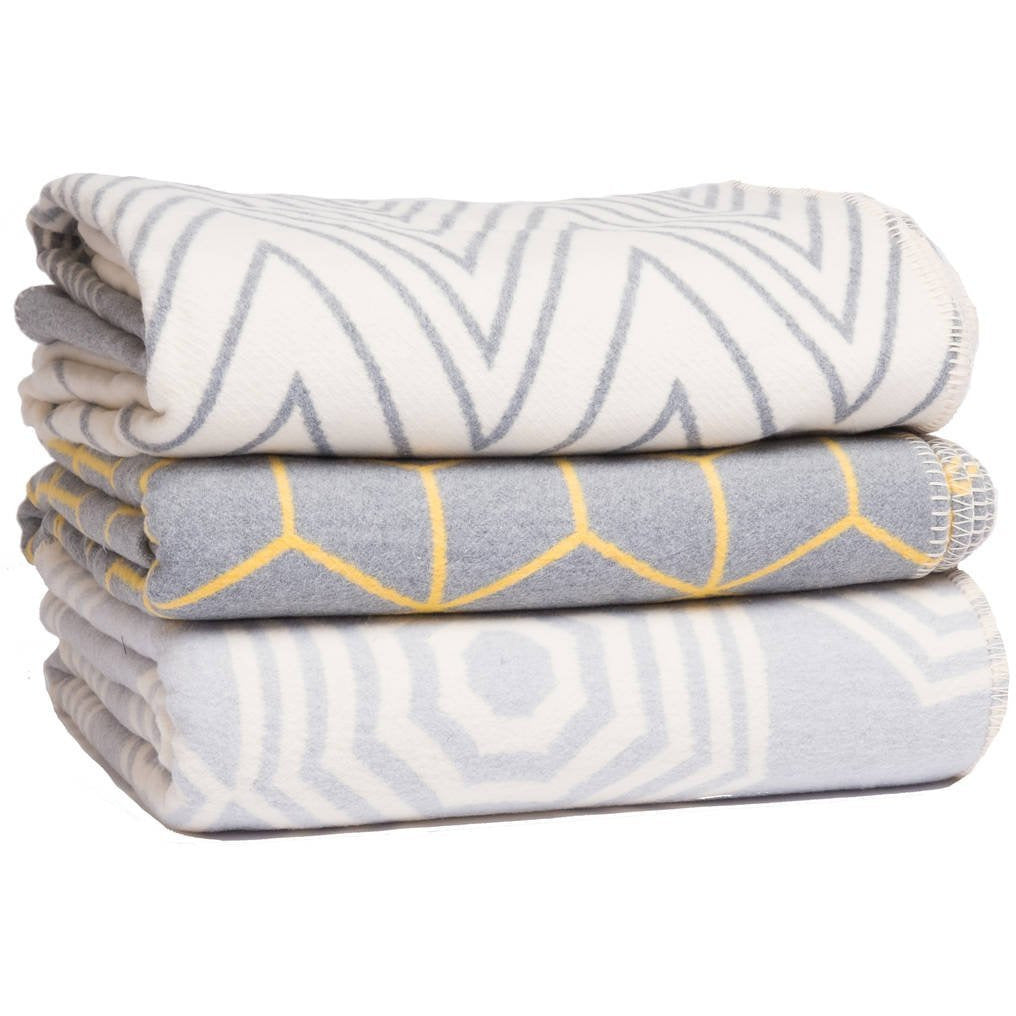 Grey Atlanta Parasol bed throw blanket on a bed, featuring a soft, cozy fabric in a single size for bedroom comfort.